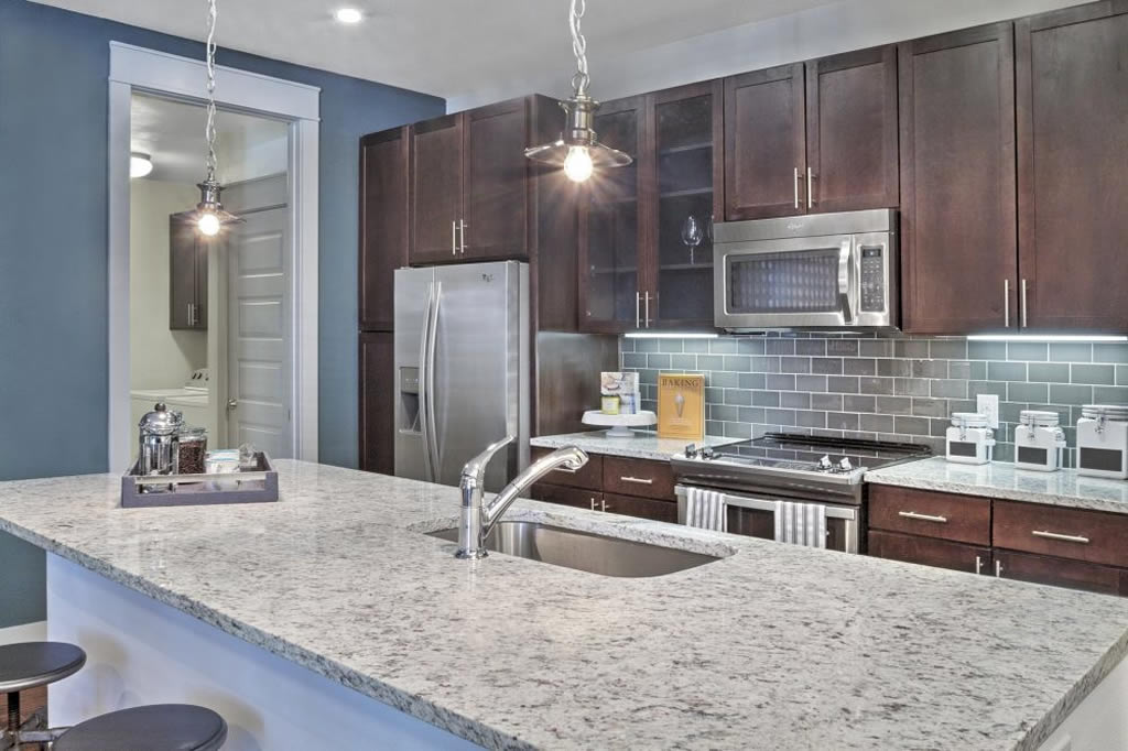 Apartments in The Heights Houston A kitchen with granite counter tops and stainless steel appliances.