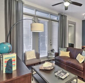 Apartments in The Heights Houston Welcome to a cozy living room with brown furniture and a ceiling fan.