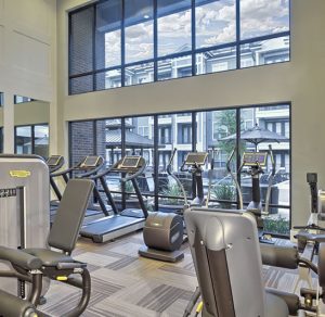 Apartments in The Heights Houston Welcome to our gym room with tread machines and large windows.
