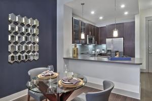 One Bedroom Apartments in The Heights Houston, TX - Model Dining Room with View to Kitchen with Breakfast Bar