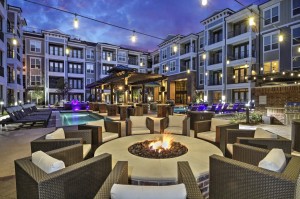 Apartment rentals in The Heights Houston, TX - Pool and Patio with Lots of Seating and Fire Pit Lit Up at Night     